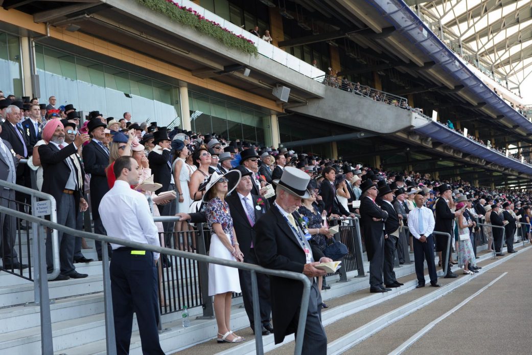 Racegoers watch the racing action from the shady stands ascot 2017